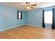 Light-blue bedroom with wood flooring and ceiling fan at 18933 Sunterra Dr, Land O Lakes, FL 34638