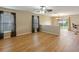Open living room with hardwood floors and kitchen access at 18933 Sunterra Dr, Land O Lakes, FL 34638