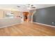 Open living room with hardwood floors and kitchen access at 18933 Sunterra Dr, Land O Lakes, FL 34638