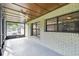 Cozy screened-in porch with tiled floor and ceiling fan at 7024 Filbert Ln, Tampa, FL 33637