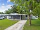 Charming ranch-style house with a screened porch and a spacious lawn at 7024 Filbert Ln, Tampa, FL 33637