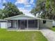 Front view of a charming house with a screened porch at 7024 Filbert Ln, Tampa, FL 33637