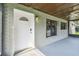 Screened porch entrance with white door and brick wall at 7024 Filbert Ln, Tampa, FL 33637