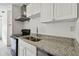 Modern kitchen with granite countertops and double sink at 7024 Filbert Ln, Tampa, FL 33637