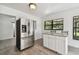 Kitchen with stainless steel refrigerator and granite island at 7024 Filbert Ln, Tampa, FL 33637