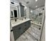 Updated bathroom featuring double vanity and a walk-in shower at 18135 Canal Pointe St, Tampa, FL 33647