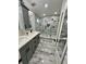 Modern bathroom with double vanity, large shower, and gray tile at 18135 Canal Pointe St, Tampa, FL 33647