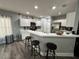 Modern kitchen with white cabinets, breakfast bar, and gray flooring at 18135 Canal Pointe St, Tampa, FL 33647