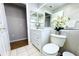 Bright bathroom featuring a white vanity, stylish mirror, and decorative floral arrangement at 13451 Knotty Ln, Hudson, FL 34669