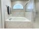 Soaking tub with tile surround, window with valance, and glass shower doors at 13451 Knotty Ln, Hudson, FL 34669