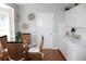 Cozy breakfast nook features wicker chairs, a glass table, and bright white cabinets at 13451 Knotty Ln, Hudson, FL 34669