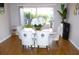 Elegant dining area boasts modern chairs, stylish decor, and natural light at 13451 Knotty Ln, Hudson, FL 34669