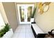Inviting foyer features tiled floors, neutral walls, a woven bench, and decorative accents at 13451 Knotty Ln, Hudson, FL 34669