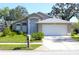 Charming single-story home featuring a well-maintained lawn and a two-car garage at 13451 Knotty Ln, Hudson, FL 34669
