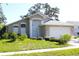 Inviting single-Gathering home with mature trees, lush landscaping, and manicured lawn at 13451 Knotty Ln, Hudson, FL 34669