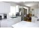 Modern kitchen with stainless steel appliances, ample counter space, and bright white cabinets at 13451 Knotty Ln, Hudson, FL 34669