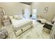 Spacious primary bedroom featuring stylish furniture, a large window, and marble flooring at 13451 Knotty Ln, Hudson, FL 34669
