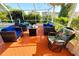 Screened patio with outdoor seating area, wicker furniture, and views of the surrounding landscape at 13451 Knotty Ln, Hudson, FL 34669
