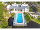 Aerial view of community pool, building, and lush landscaping at 758 Pine Run Dr # 758, Osprey, FL 34229