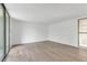 Spacious living room with sliding glass door and wood-look floors at 758 Pine Run Dr # 758, Osprey, FL 34229