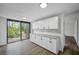 Kitchen boasts white shaker cabinets, granite countertops, and wood-look floors at 758 Pine Run Dr # 758, Osprey, FL 34229