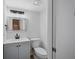 Small bathroom with gray vanity, toilet and mirror at 758 Pine Run Dr # 758, Osprey, FL 34229