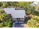 Aerial view of condo building with parking and surrounding trees at 758 Pine Run Dr # 758, Osprey, FL 34229