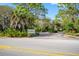 Community entrance with signage, lush landscaping and paved road at 758 Pine Run Dr # 758, Osprey, FL 34229