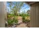 Private backyard with lush landscaping and stone pathway at 758 Pine Run Dr # 758, Osprey, FL 34229