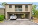 Condo exterior showcasing carport, balcony, and landscaping at 758 Pine Run Dr # 758, Osprey, FL 34229