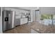 Modern kitchen with white cabinets, granite counters, and stainless steel appliances at 758 Pine Run Dr # 758, Osprey, FL 34229