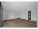 Bright living room with wood-look floors and sliding glass doors at 758 Pine Run Dr # 758, Osprey, FL 34229