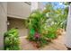 Condo entry with lush tropical landscaping and walkway at 758 Pine Run Dr # 758, Osprey, FL 34229