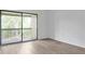 Bedroom with sliding glass door to balcony and wood-look floors at 758 Pine Run Dr # 758, Osprey, FL 34229