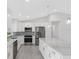 Modern kitchen featuring white cabinets and marble countertops at 10317 Gulfstream Blvd, Englewood, FL 34224