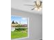 Bright bedroom featuring a large window and ceiling fan at 10317 Gulfstream Blvd, Englewood, FL 34224