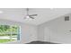 High-ceiling living room with ceiling fan and lots of light at 10317 Gulfstream Blvd, Englewood, FL 34224
