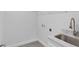 Laundry room with a marble countertop and stainless steel sink at 10317 Gulfstream Blvd, Englewood, FL 34224