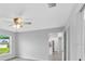 Spacious bedroom with ceiling fan and view of backyard at 10317 Gulfstream Blvd, Englewood, FL 34224