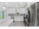 Modern kitchen with stainless steel appliances and white cabinets at 10317 Gulfstream Blvd, Englewood, FL 34224