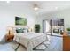Well lit bedroom with a queen sized bed, ceiling fan and sliding glass doors to the outdoor patio at 1314 Pelican Creek Xing # 1314, St Petersburg, FL 33707