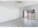 Bright bedroom featuring wood look tile floors, a ceiling fan, and sliding glass doors to the balcony at 1314 Pelican Creek Xing # 1314, St Petersburg, FL 33707