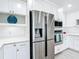 Modern kitchen featuring stainless steel appliances, white cabinets, and quartz countertops at 1314 Pelican Creek Xing # 1314, St Petersburg, FL 33707