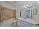 Bathroom with walk-in shower and updated vanity at 633 Tremont Greens Ln # 16, Sun City Center, FL 33573