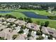 Aerial view of home showcasing its location near a golf course and lake at 633 Tremont Greens Ln # 16, Sun City Center, FL 33573