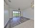 Bright dining room with wood-look floors and sliding glass doors at 633 Tremont Greens Ln # 16, Sun City Center, FL 33573