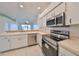 Kitchen with stainless steel appliances and view to living room at 633 Tremont Greens Ln # 16, Sun City Center, FL 33573