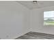 Bedroom with vinyl flooring, large window and golf course view at 633 Tremont Greens Ln # 16, Sun City Center, FL 33573