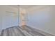 Simple bedroom with grey wood-look floors and double door closet at 633 Tremont Greens Ln # 16, Sun City Center, FL 33573