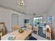 Virtually staged dining area with open concept to living room at 633 Tremont Greens Ln # 16, Sun City Center, FL 33573